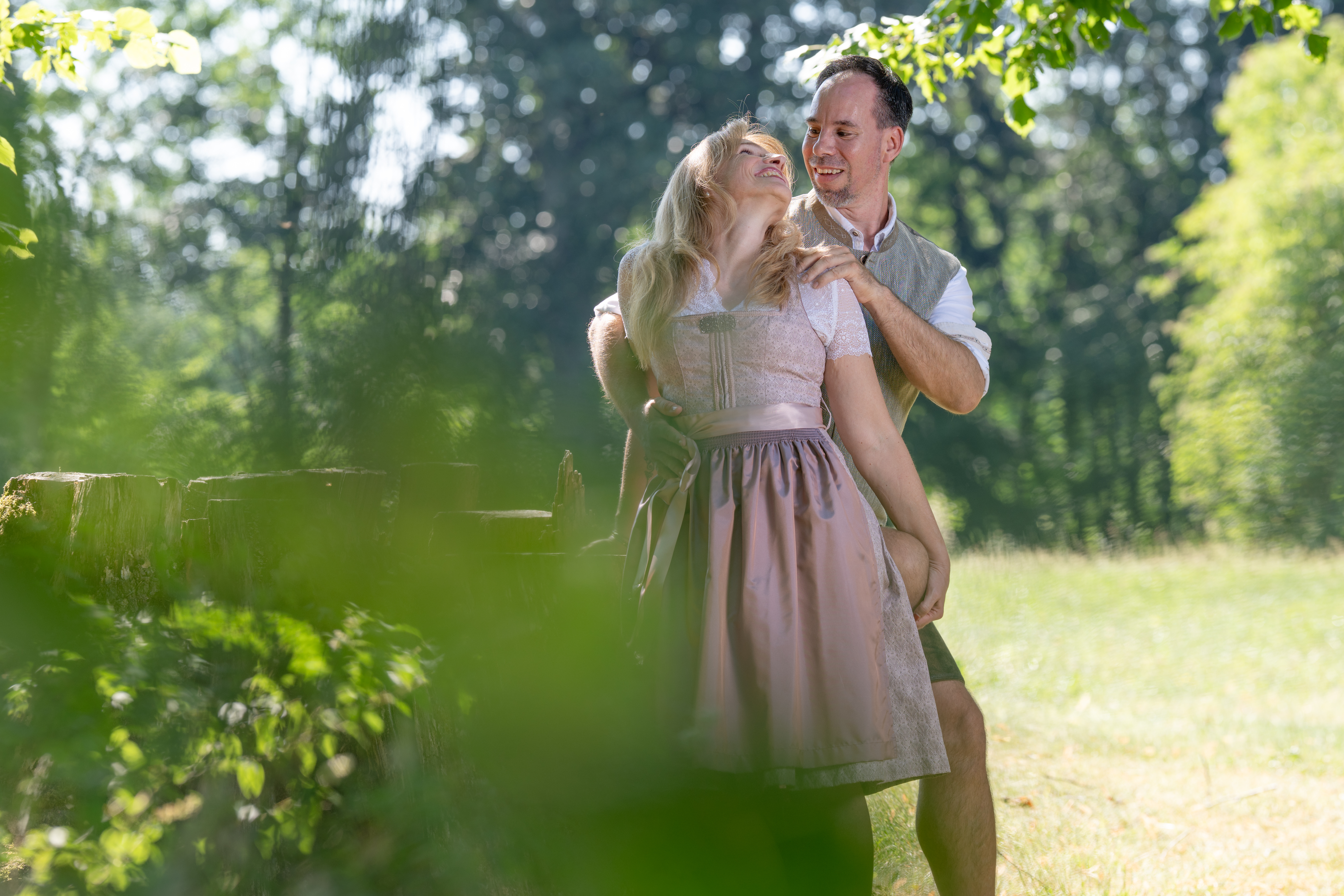 Petra und Markus lachen gemeinsam im weichen Sommerlicht